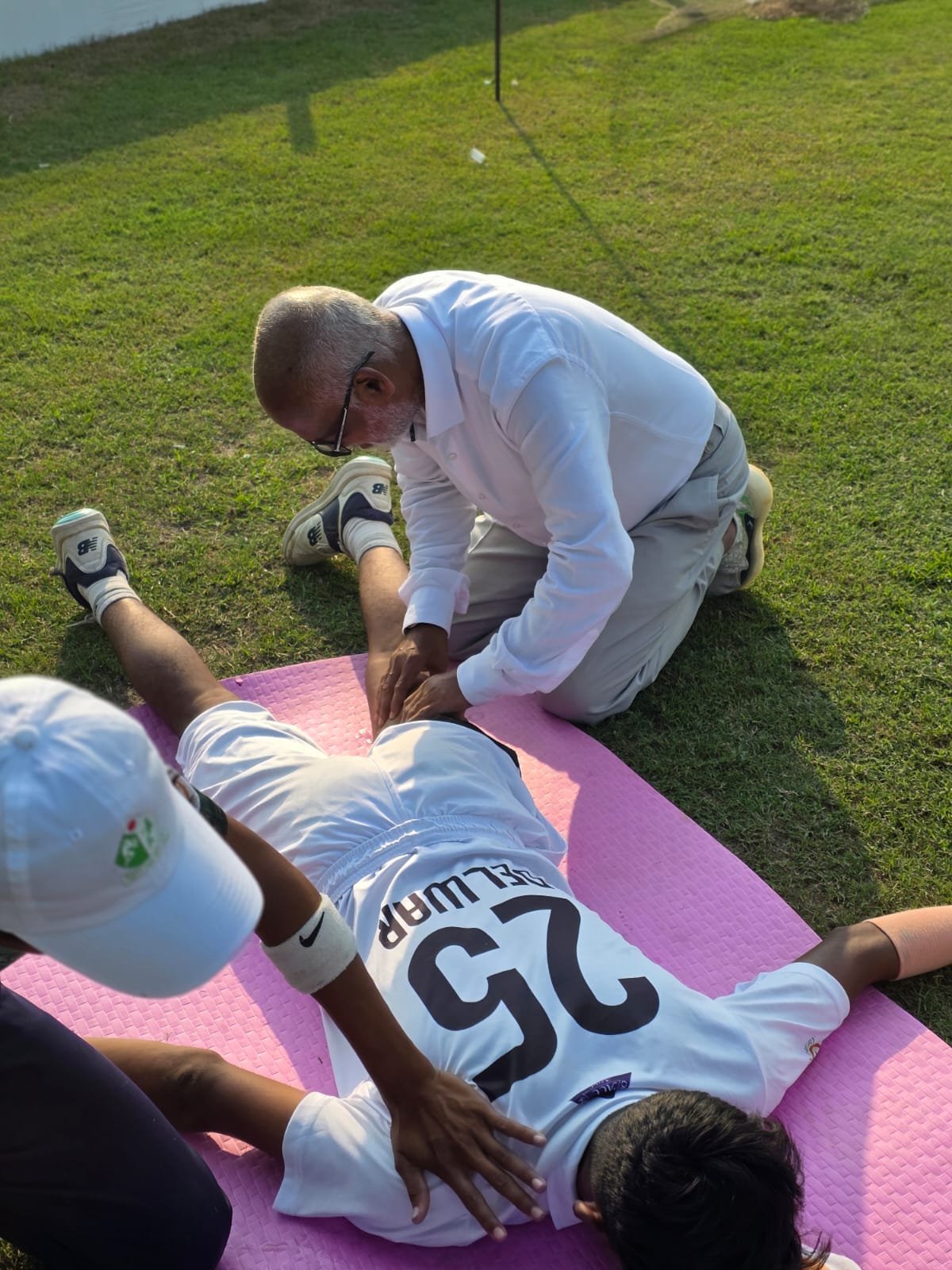 Mr. MD Akbar Babul helping players to do some stretching