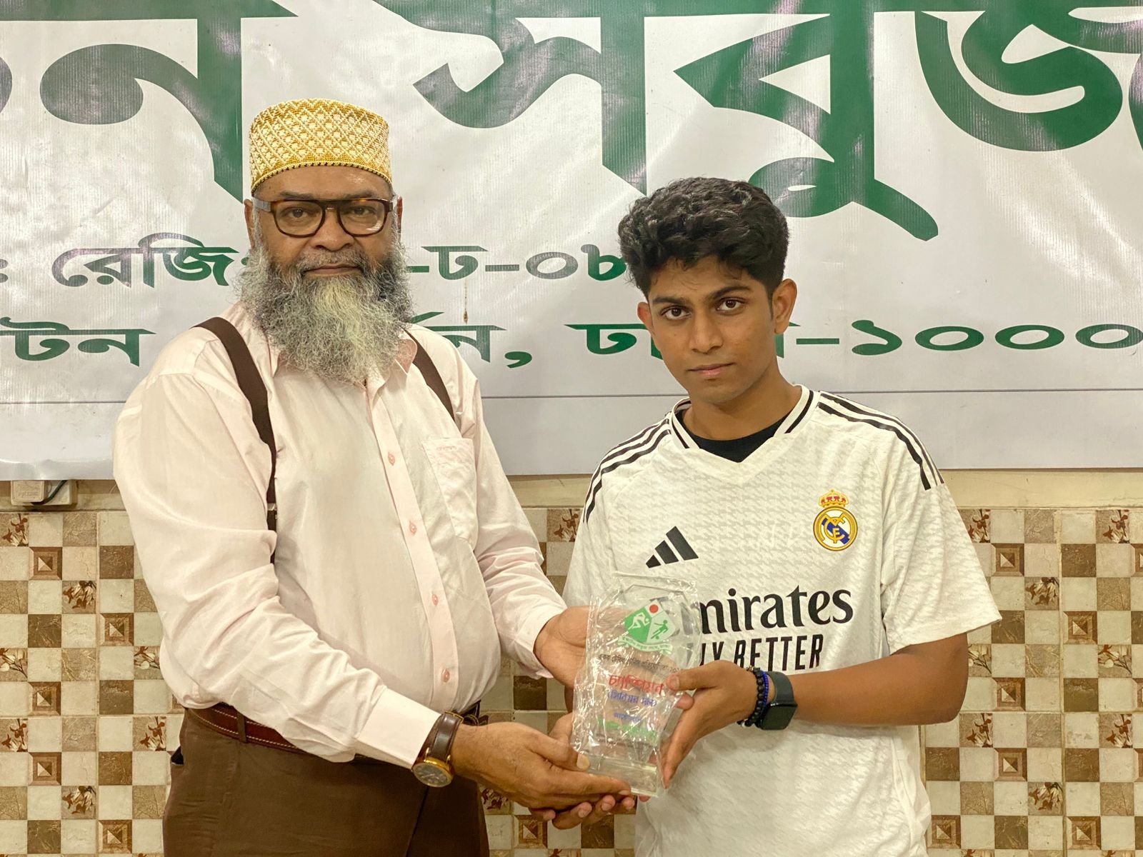 ESS Senior Friendly Table Tennis 2025 Tournament Champion Fuad receiving reward from Mr. Monirul Islam Pitu